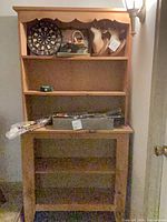 Front view of pine bookcase with four shelves and scalloped top trim