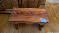 Top view of solid pine bench showing grain, wear, sticker