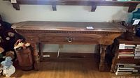 Front view of console table showing overall design, drawer, legs, and lower shelf