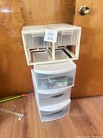 Front view of Sterilite three-drawer tower with top organizer showing drawers and contents