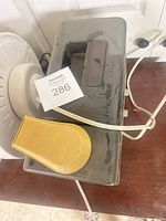 Top view of Tatung ice shaver showing yellow handle, smoked lid and power cord