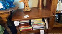 Front angle view showing entire brown wood veneer end table with lower shelf