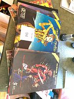 Stack of AD&D hardcovers with Fiend Folio and Dungeon Masters Guide visible