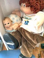 Rag doll and porcelain baby figurine
