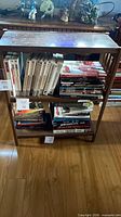 Front view of narrow oak-tone bookshelf with three shelves