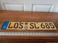 Full view of license plate with ruler showing length