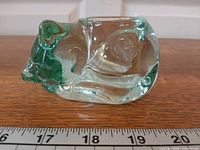 profile view of glass sleeping cat showing form and color