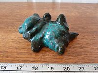 Top view of Blue Mountain Pottery rolling cat showing drip glaze and overall form next to ruler