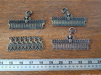All four pendants with ruler for scale