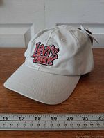 Three-quarter front view of beige Levi's cap showing embroidered logo and brim