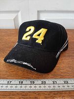 Front view showing yellow 24 embroidery and signature on brim