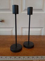 Front view showing both candlesticks, bases, and scale