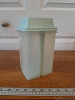 Container front view showing translucent base and mint lid