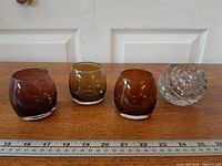 All four votive holders lined with ruler for scale