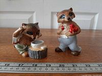 Both Goebel Ringtale Raccoons figurines with ruler for scale