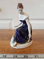 Full view of figurine with ruler indicating height