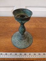 Front view showing overall form, patina and floral pattern