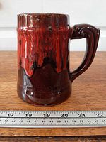 Full view of mug front showing glaze and size reference