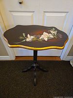 Top view showing scalloped shape, floral painting and gold trim