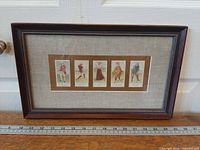 Front view showing full framed print with ruler for scale
