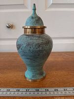 Front view of brass temple jar showing patina and shape