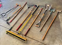 Full set of garden tools laid out showing heads and handles