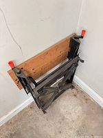 Workbench folded, showing wood top panels and steel frame