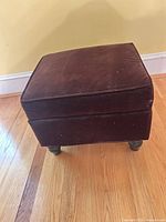 Overall view of ottoman showing upholstery and legs