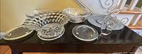 Group view of all six clear glass pieces on table
