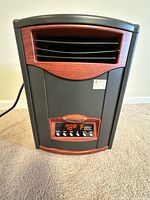 Front view of Comfort Furnace CF1500 heater showing vent, trim, and power cord