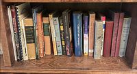 Full shelf showing 17 assorted history and military books