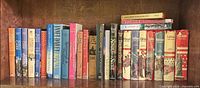 Full shelf showing all 26 books arranged left to right