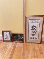 Three of the framed items: vertical club illustration, caricature golfer print, golf shadow box