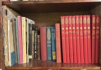 Whole shelf showing sheet music folios left, mixed music books centre, Scribner’s Music Library red volumes right