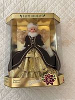 Front view of boxed Happy Holidays Barbie showing doll, gown, and gold box header