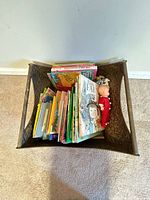 Top view of metal holder filled with books and doll