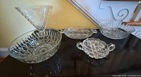 Group shot of all five clear pressed glass pieces