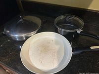 Overview showing skillet, sauté pan with lid, saucepan with lid