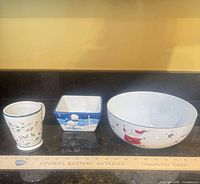 All three ceramic pieces lined beside ruler for scale