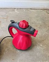 Main body of red/black Scünci SS1000 handheld steam cleaner