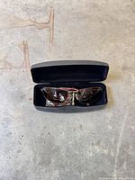 Sunglasses in case showing front view