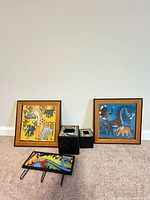 Group shot showing both framed prints, three boxes and wall rack