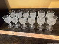 All 12 Diamond Point wine glasses lined up on countertop