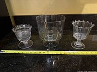 All three pressed glass pieces with tape measure for scale