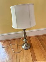Full view of lamp showing brushed nickel base and white drum shade