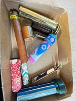 Box containing nine assorted kaleidoscopes of various materials and colours