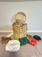 Full lot with wicker hamper, clutch, three hats, two fur stoles visible