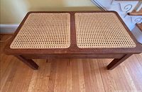 Top view of bench showing twin cane panels and wood frame