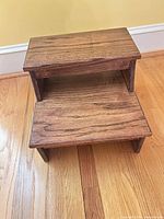 Front angled view showing two steps and wood grain