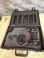 Kit overview in case showing rivet gun, battery, charger, foam insert